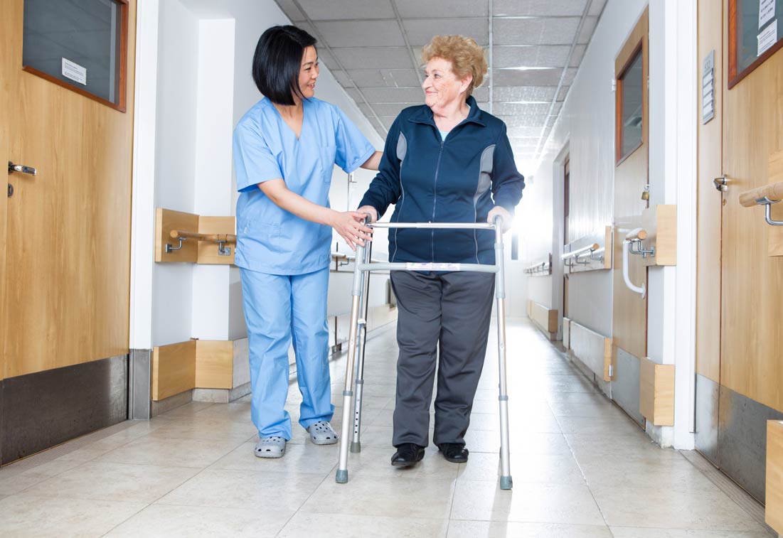 Nurse assisting elder people in a rehab facility gym